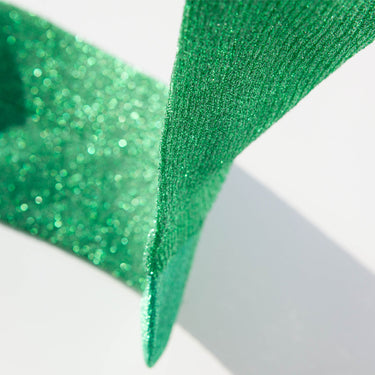 Close-up of green glittery ribbon on a white background